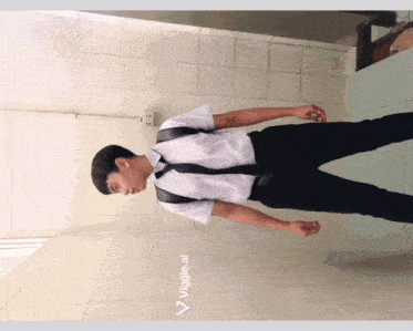 a man in a white shirt and black tie is standing in a bathroom with the words veggie.ai below him