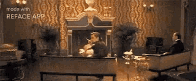 a man is smoking a cigarette while sitting in front of a fireplace .