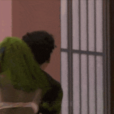 a man and a woman are sitting in front of a window in a room .