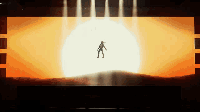a silhouette of a woman standing in front of a large sun