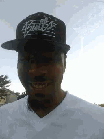 a man wearing a hat that says chicago bulls on it