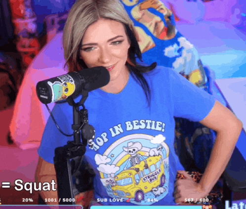 a woman wearing a blue shirt that says " hop in bestie "
