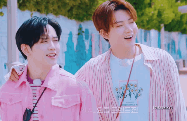 two young men are standing next to each other with a watermark that says tomashkyu
