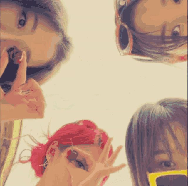 a group of women are posing for a picture and one of them has red hair