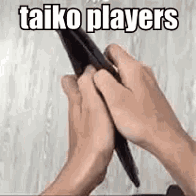 a person is holding a pen in their right hand and a tablet in their left hand .