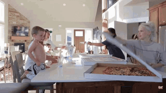 a woman is cutting a pizza with a knife