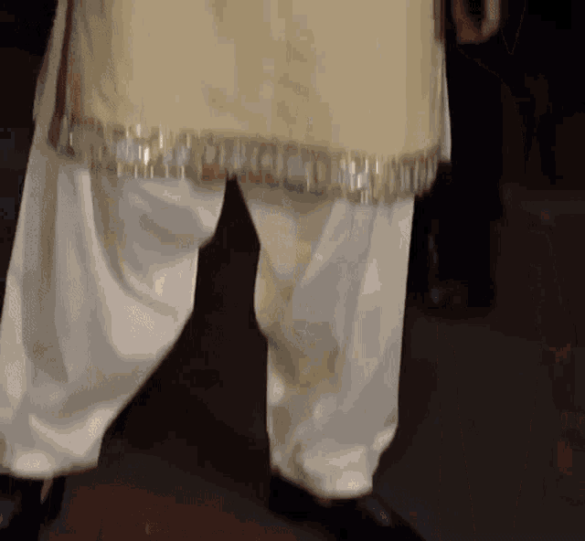 a close up of a person 's pants with gold trim