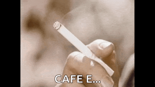 a person is holding a cigarette in their hand with the words cafe e written on the bottom .