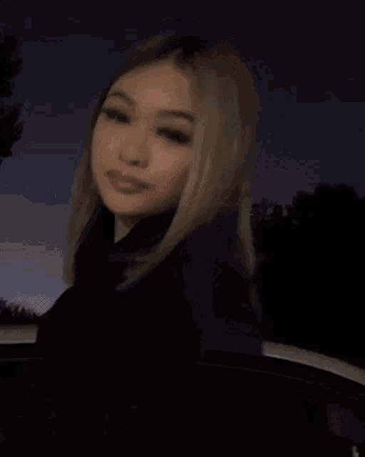a close up of a woman 's face with blonde hair and pink lips .