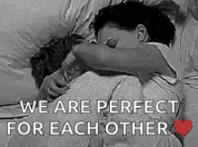 a black and white photo of a couple hugging each other .