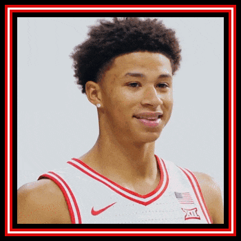 a basketball player wearing a white jersey with a red and white border