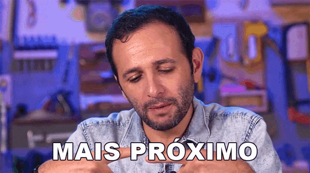 a man in a denim shirt says mais proximo in a foreign language