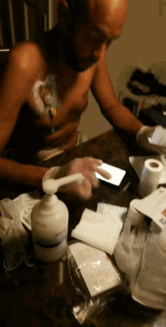 a man sitting at a table with a bottle of lotion on it that says ' johnson & johnson ' on it