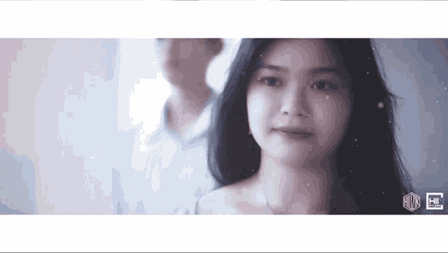 a man and a woman are standing next to each other and looking at each other .