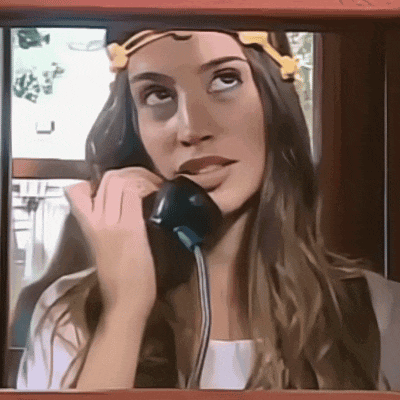 a woman is talking on a phone with a yellow flower in her hair