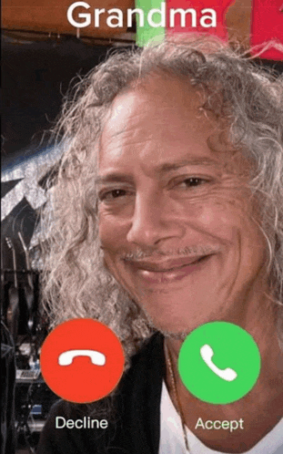 a man with curly hair is talking to his grandma on a cell phone