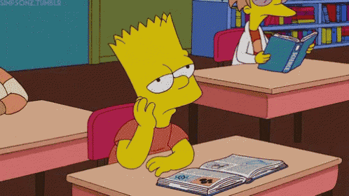 bart simpson sits at a desk in a classroom reading a book