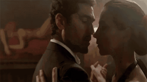 a man and a woman are dancing in a dark room .