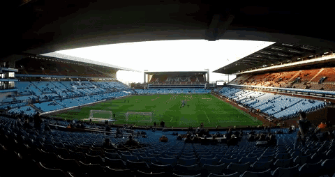 an empty soccer stadium with the word arsenal on the side
