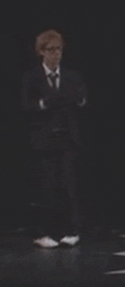 a blurred image of a man in a suit and tie