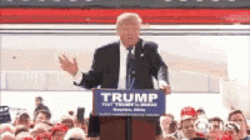 donald trump is giving a speech at a podium with a sign that says trump on it .