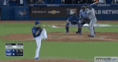 a baseball game is being played in front of a mlb network sign .