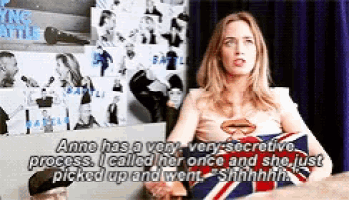 a woman in a superman costume is sitting in a chair with a british flag pillow .