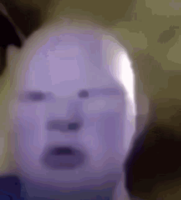a close up of a person 's face with a purple mask on .