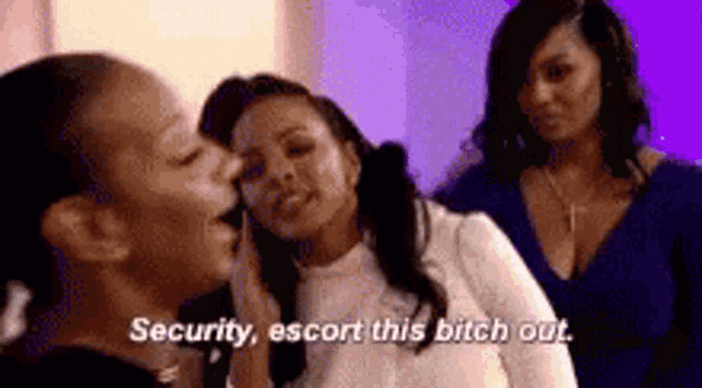 a group of women are standing next to each other and one woman is saying `` security , escort this bitch out '' .