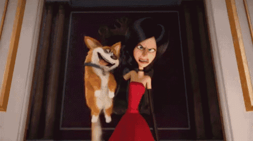 a woman in a red dress is standing next to a corgi dog .