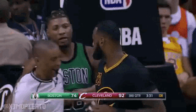a basketball game is being played between boston and cleveland .
