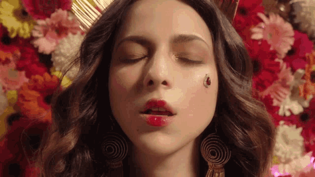 a woman with her eyes closed has a ladybug on her cheek