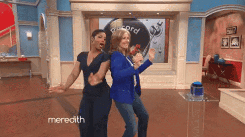 two women are dancing in a room with meredith written on the bottom