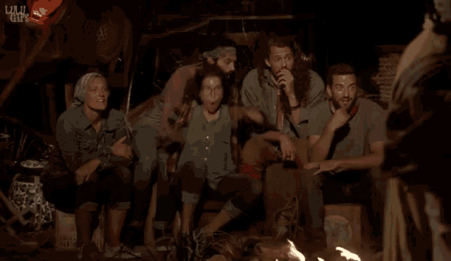 a group of people sitting around a fire with the words www.gifs visible in the corner