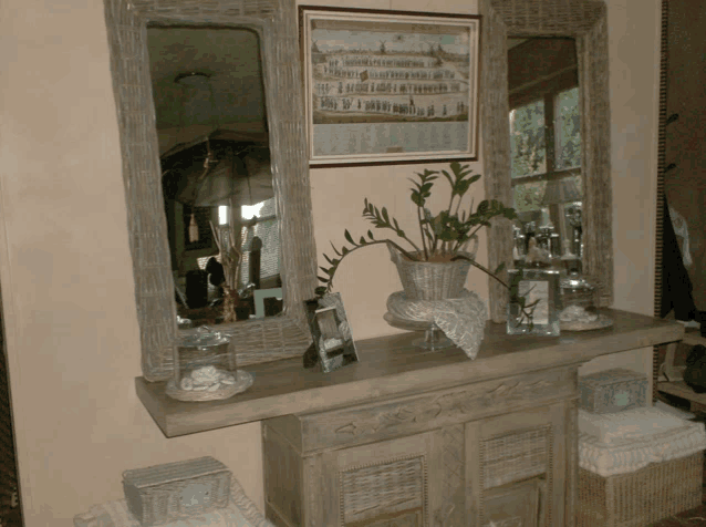 a dresser with a picture on the wall above it