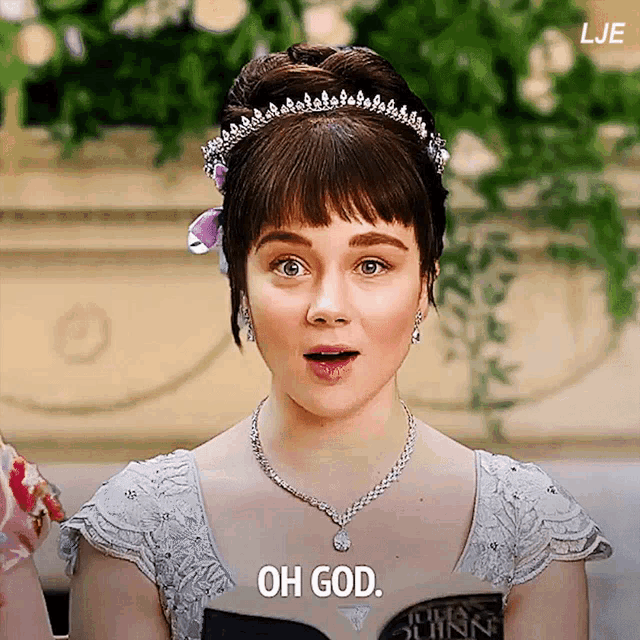 a woman wearing a tiara and a necklace is saying oh god