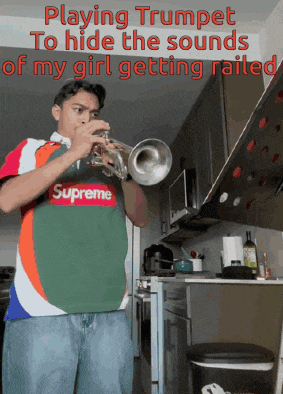 a man wearing a supreme shirt plays a trumpet