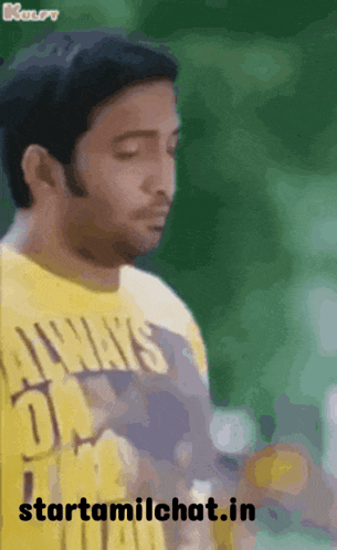 a man wearing a yellow t-shirt with the words always on it
