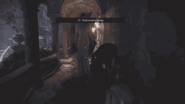 a woman in a large hat is standing in a dark hallway