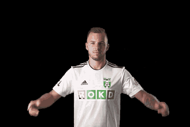 a man wearing a white shirt that says rokd