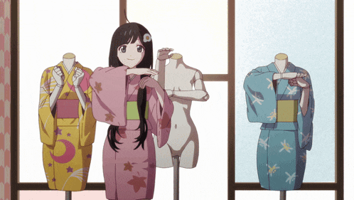a girl in a pink kimono is standing next to two mannequins