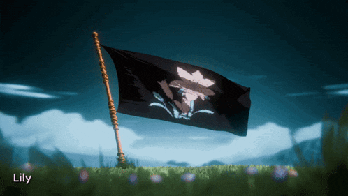 a black flag with a flower on it is flying in the wind