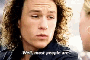 a man with curly hair is talking to a woman and says well most people are .