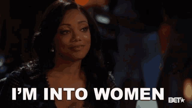 a woman is holding a glass of wine and saying i 'm into women .