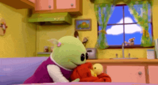 a girl is sitting on a couch with a stuffed animal .