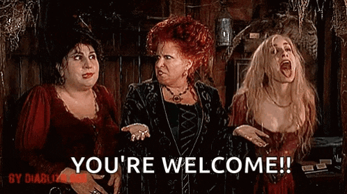 three women are standing next to each other in a room and one of them is saying you 're welcome !