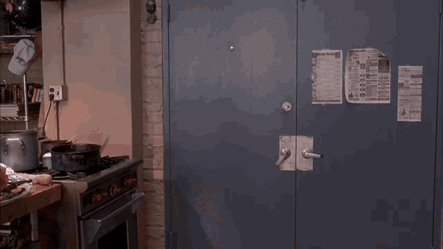a man in a suit and tie is standing in a kitchen with a can of soda