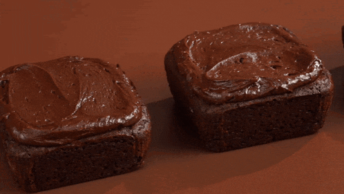 a close up of a brownie with chocolate frosting on top