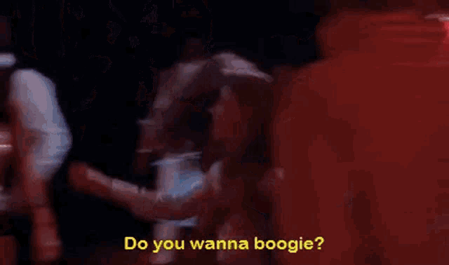 a woman in a wonder woman costume is dancing with a man at a disco .