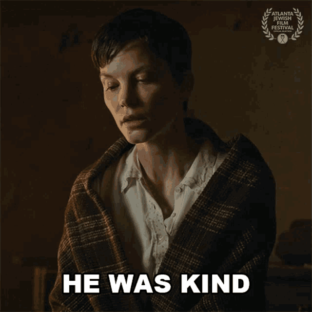 a woman is wrapped in a plaid blanket and the words he was kind are above her